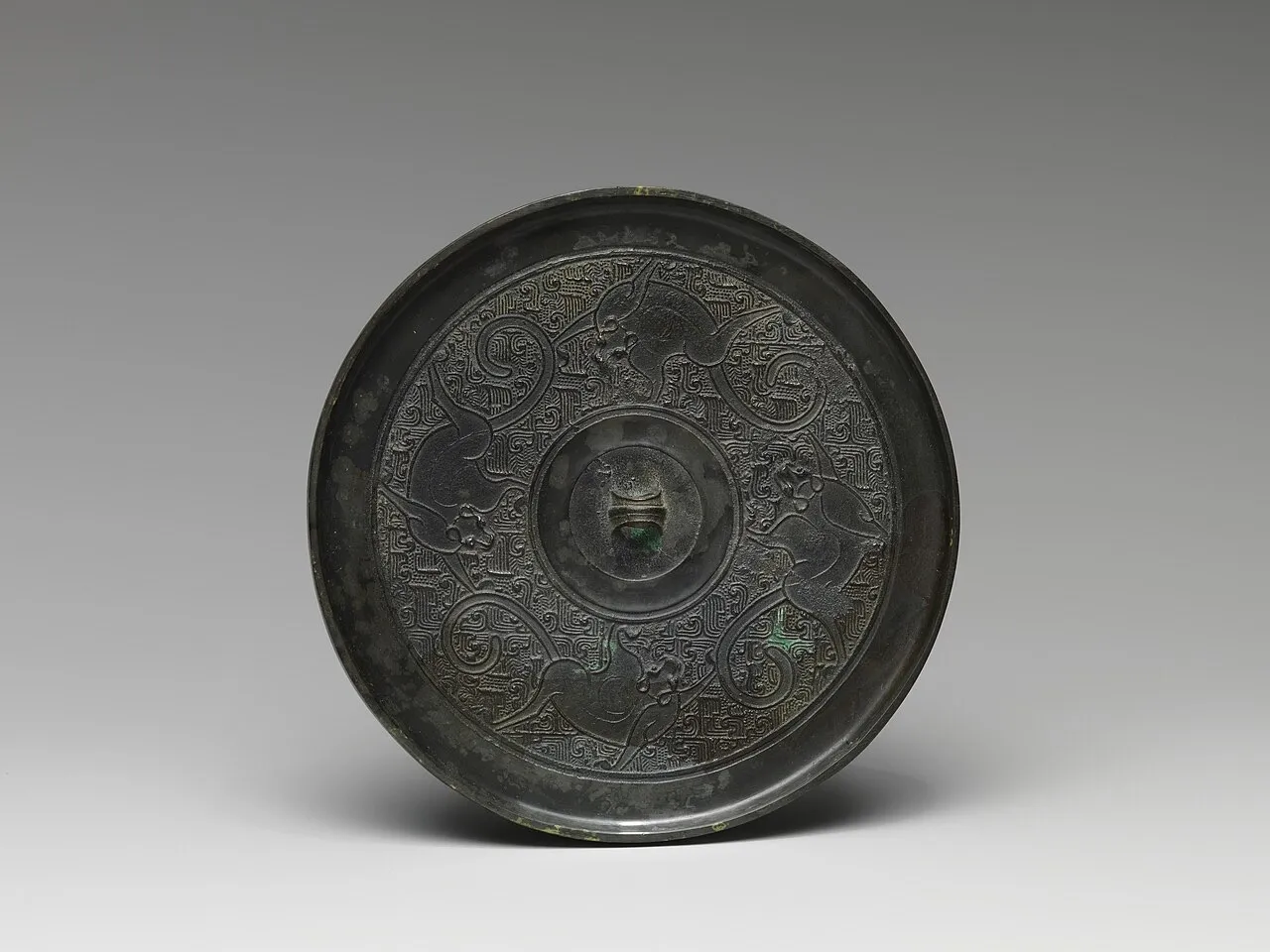 (2) A Chinese bronze mirror with a pattern
